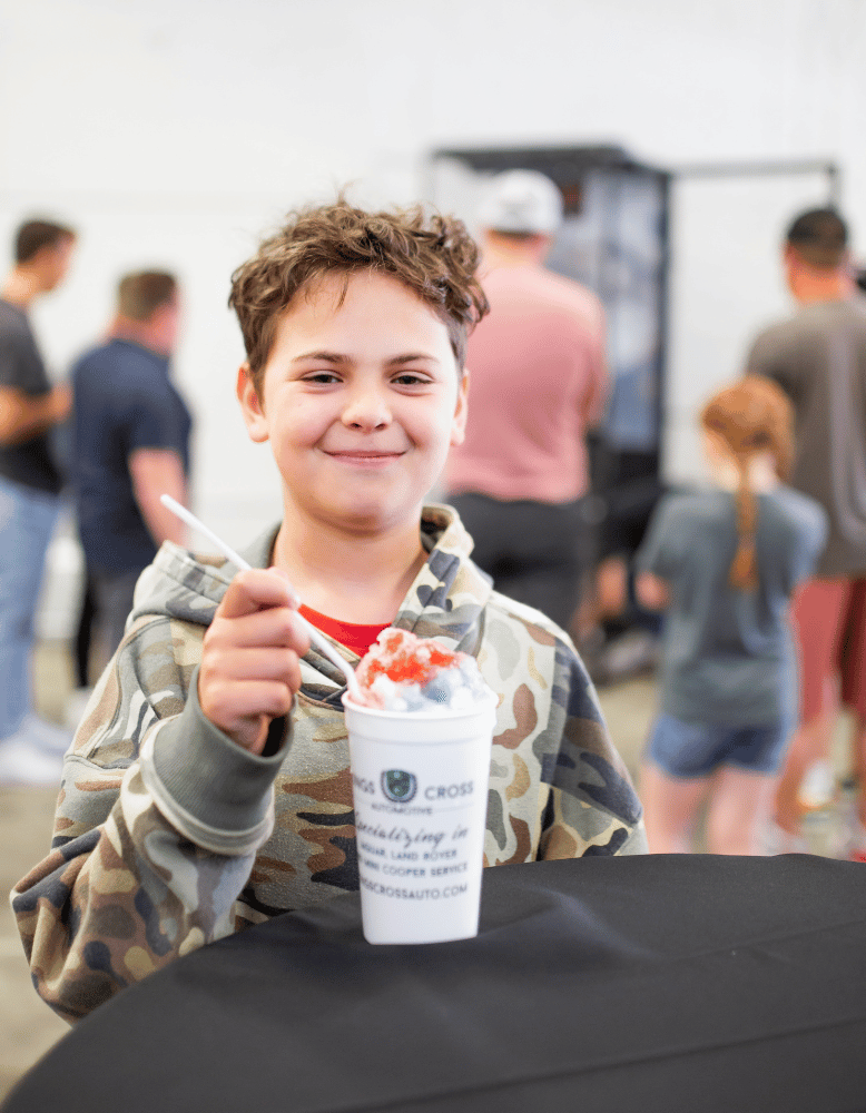 Kid eating Kona ice at Kings Cross Automotive's British Block Party