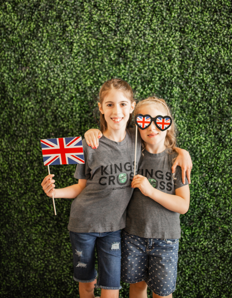 Two kids of Kings Cross Automotive posing with British style props.