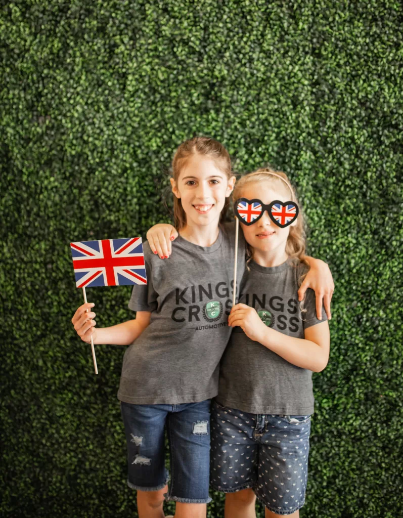 Two kids of Kings Cross Automotive posing with British style props.